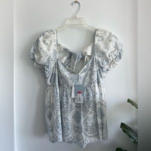 Eyelet & bow peplum top